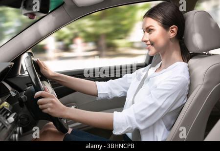 Jeune femme d'affaires conduisant sa nouvelle voiture Banque D'Images