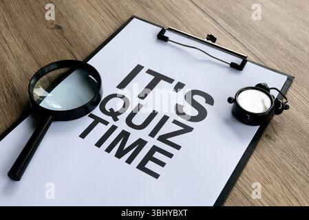 Concept de préparation du quiz urgent avec presse-papiers, réveil et loupe Banque D'Images