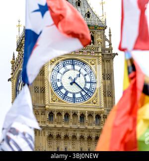 Londres, Royaume-Uni. 'Big Ben' (Elizabeth Tower) sur la place du Parlement avec divers drapeaux flottant Banque D'Images