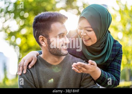 Portrait d'un couple musulman heureux s'embrassant dans la ville Banque D'Images