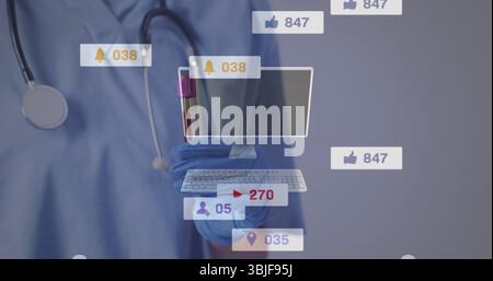 Tenant le tube de sang avec un bouchon violet, infirmière dans des gommages bleus avec stéthoscope en utilisant des icônes dans le laboratoire Banque D'Images