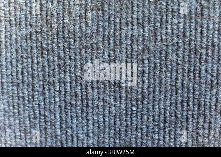 Une vue détaillée capture la texture complexe du tissu tissé avec des lignes verticales bleues. Le tissu semble durable et est probablement utilisé pour les vêtements Banque D'Images