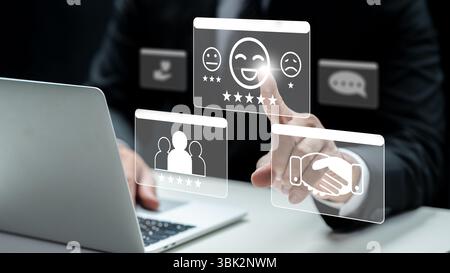 Homme d'affaires utilisant un ordinateur portable touche l'icône d'un visage souriant avec une note de cinq étoiles. Innovation technologique sur un écran virtuel. Concept de client ou Banque D'Images