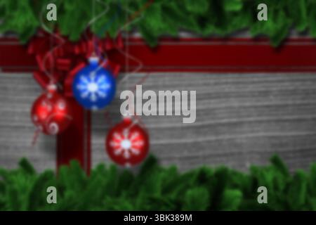 Motif plat festif représentant des boules de Noël suspendues à un noeud en ruban rouge sur un panneau de bois gris Banque D'Images
