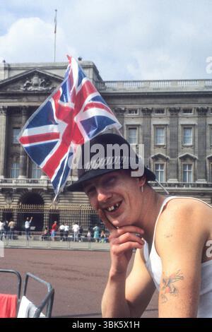 Homme portant le drapeau Union Jack devant le palais de Buckingham pour le mariage du Prince Andrew et de Sarah Ferguson le 23rd 1986 juillet Banque D'Images