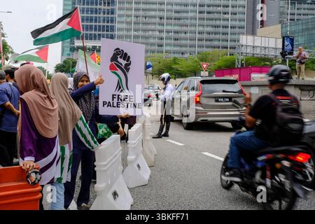 Kuala Lumpur, Malaisie. 20 juin 2025. Un manifestant donne le pouce à un motocycliste de soutien lors d'un rassemblement de solidarité pacifique. Les manifestants marchent ensemble dans un rassemblement de solidarité pacifique pour condamner Israël et son allié l'État-Unis pour avoir attaqué les peuples iranien et palestinien à Gaza. Crédit : SOPA images Limited/Alamy Live News Banque D'Images