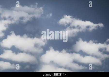 Les nuages de cumulus blancs flottent à travers le ciel bleu profond dans l'art vectoriel de conception plate Banque D'Images