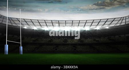Des poteaux de but de rugby de conception plate se tiennent à gauche dans le stade, mettant en valeur le terrain vert et les projecteurs Banque D'Images