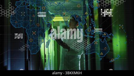 Atteindre un ingénieur coréen portant une blouse de laboratoire tenant une tablette dans le couloir vert du centre de données, carte du réseau Banque D'Images