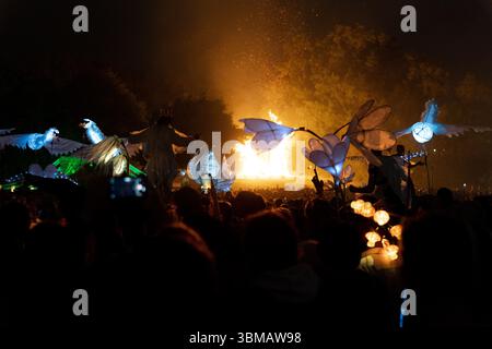 Londres, Royaume-Uni. 25 juin 2025. La zone Green Fields du Festival de Glastonbury s'ouvre ce soir avec une cérémonie dirigée par la « flamme de l'espoir » partagée, réunissant 15 flammes sacrées du monde entier. Un refrain de plus de mille voix chante un mantra de paix dans King's Meadow suivi d'un spectaculaire feu d'artifice. L'événement crée un puissant sentiment d'unité et de but, marquant le début officiel du festival dans ce calme et spirituel cœur du site (photo de Joao Daniel Pereira/Sipa USA) crédit : Sipa USA/Alamy Live News Banque D'Images