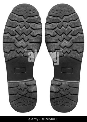 Photo isolée de chaussure en caoutchouc de couleur noire motif protecteur usé sur fond blanc. Banque D'Images