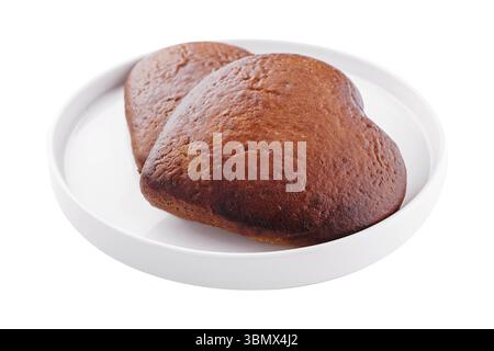 Nature morte de nourriture, gros plan de deux biscuits en forme de coeur sur l'assiette Banque D'Images
