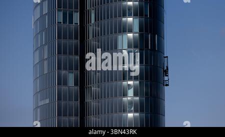 Duesseldorf, Allemagne. 30 juin 2025. Un endroit ombragé à une hauteur élevée : un nettoyeur de façade nettoie les fenêtres du côté ombragé d’un immeuble de bureaux de grande hauteur. Dans les prochains jours, il fera très chaud en Allemagne avec des températures de plus de 30 degrés Celsius. Crédit : Rolf Vennenbernd/dpa/Alamy Live News Banque D'Images