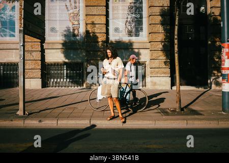 Belgrade, Serbie - 28 juin 2025 : un homme utilise un téléphone dans la rue du centre-ville, saison estivale. Banque D'Images
