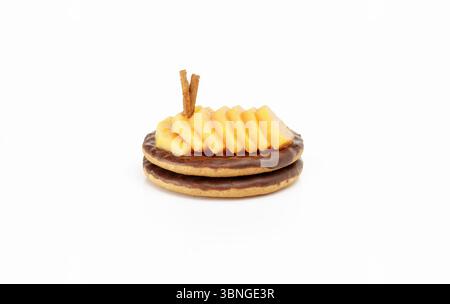 Deux biscuits au chocolat avec des tranches de papaye décorées de bâtonnets de cannelle Banque D'Images