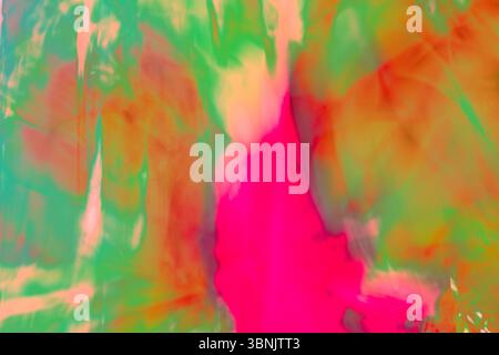 Art abstrait vibrant affichant un mélange fluide de couleurs, soulignant le concept de chromadynamique avec un mélange fascinant de rose, vert et orange Banque D'Images