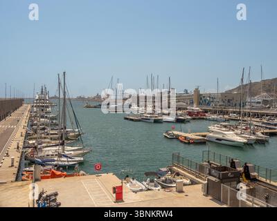 Vue en angle élevé sur le vaste port de plaisance du port de Barcelone, montrant les quais remplis de bateaux de plaisance et le brise-lames principal au loin. Espagne Banque D'Images
