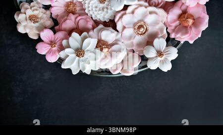 Sam Pan Nee, dessert thaïlandais dans un ton de couleur rose pastel avec diverses formes de fleurs, goût de saveur de lait de coco, authentique collation artisanale traditionnelle thaïlandaise Banque D'Images