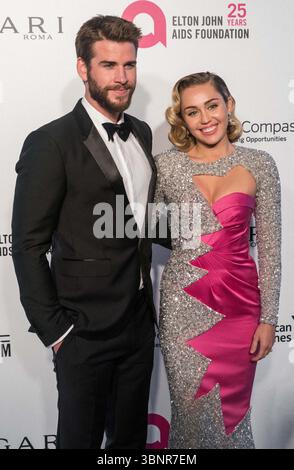 (FILE) Miley Cyrus recevra une étoile sur le Hollywood Walk of Fame en 2026. Miley Cyrus fait partie des 35 lauréats annoncés le mercredi 2 juillet 2025 par Eugenio Derbez et Richard Blade. WEST HOLLYWOOD, LOS ANGELES, CALIFORNIE, États-Unis - MARS 04 : L'acteur australien Liam Hemsworth portant un tux Burberry et sa petite amie/chanteuse américaine, auteur-compositeur et actrice Miley Cyrus portant une double robe rose et scintillante Moschino arrive à la 26e soirée annuelle des Oscars de la Fondation Elton John AIDS qui s'est tenue au City of West Hollywood Park le 4 mars 2018 à West Hollywood, Los Angeles, Californie, Unit Banque D'Images