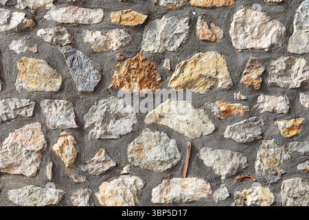 Vieux mur en pierre fait de grandes pierres naturelles grises. Fond de texture rustique de mur de pierre. Banque D'Images