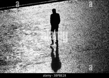 Années soixante, sport, football, Bundesliga, 1967/1968, MSV Duisburg v. SV Werder Brême 1-1, Wedau Stadium à Duisburg, match par temps pluvieux sous la lumière des inondations, jeune homme sans aucun abri de pluie se tient sur la touche comme une silhouette Banque D'Images