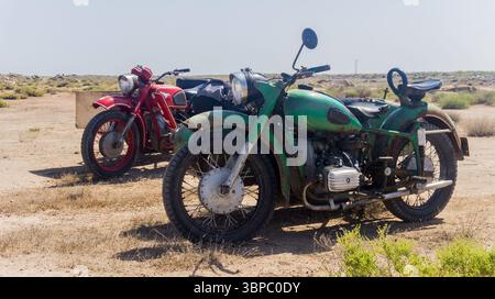 Deux motos de style ancien garées dans un champ de style désert Banque D'Images