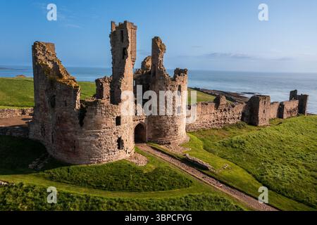 Vue aérienne des ruines du château de Dunstanburgh sur la côte de Northumberland, au nord-est de l'Angleterre, au Royaume-Uni Banque D'Images