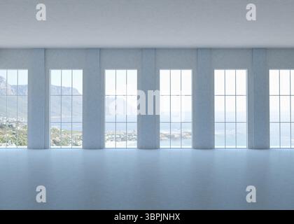 Le hall design plat est doté d'un sol en béton, de colonnes encadrant des fenêtres pleine hauteur donnant sur la mer Banque D'Images
