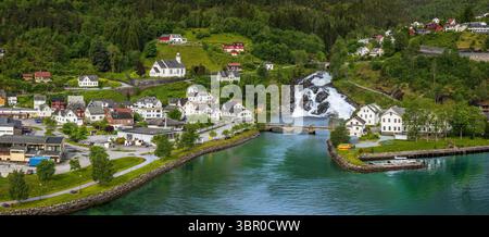 Vue sur Hellesylt, un petit village dans le Sunnylvsfjord, Norvège. Capturée depuis un grand bateau de croisière, la scène présente un paysage verdoyant Banque D'Images
