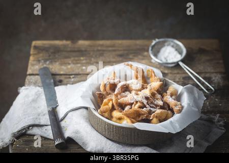 Broussailles - cookies traditionnel russe avec du sucre en poudre. Plaque avec hvorost on wooden table Banque D'Images