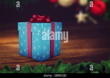 Boîte cadeau bleu flocon de neige est assis sur une table dans un design plat, avec ruban rouge et ornements Banque D'Images