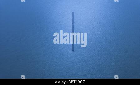 Vue aérienne d'une jetée solitaire s'étendant dans les eaux calmes et bleues profondes de l'océan Pacifique, San Francisco, Californie, États-Unis. Banque D'Images