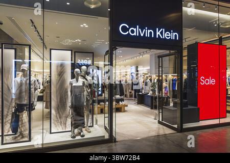 L'élégante vitrine Calvin Klein présente des mannequins, un éclairage moderne et un panneau de vente rouge audacieux. Londres, Royaume-Uni, 4 juillet 2023 Banque D'Images