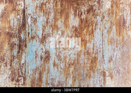 Fond multicolore : surface métallique rouillée avec écaillage de peinture bleue et texture fissurante Banque D'Images