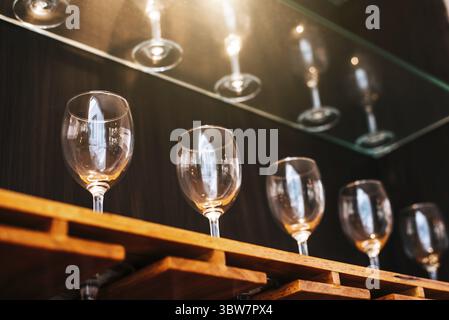Boire des verres à vin étagère dans restaurant avec vitrine éclairage arrière-plan. De nombreux conteneurs propres au restaurant ou pub et bar de nuit. L'intérieurapt decora Banque D'Images