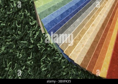 Les échantillons de la collection linoléum multicolore sur fond de tapis vert Banque D'Images