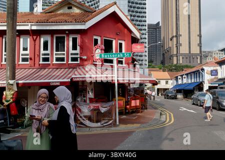 Bussorah Street à Kampong Glam, un quartier charmant et coloré dominé par les Malais à Singapour ; avec deux femmes malaises portant un foulard au premier plan Banque D'Images