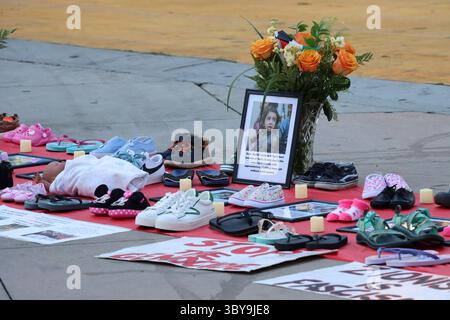Un mémorial avec des chaussures pour enfants, des drapeaux palestiniens et des bougies est aménagé lors d’une manifestation organisée par Burbank pour la Palestine, le 16 juillet 2025. Banque D'Images