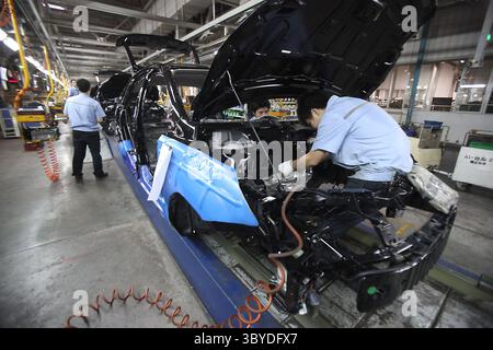 25 août 2010, CHONGQING, CHINE : des travailleurs chinois assemblent des voitures Ford et Volvo dans une usine d'assemblage automobile Chang'an Ford à Chongqing le 25 août 2010. Chang'an Ford est la coentreprise chinoise de Ford Motor Company. La Chine est le marché automobile le plus chaud en termes de nombre de véhicules vendus, et les constructeurs automobiles se tournent vers le pays pour générer des revenus dans un contexte de faible demande mondiale. (Crédit image : © Stephen Shaver/ZUMA Press Wire) Banque D'Images