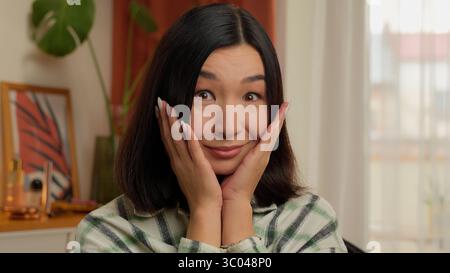 Étonné heureux asiatique coréen femme japonaise femme excitée fille d'affaires émotions surprise d'intérieur wow portrait bouche ouverte grands yeux femme au foyer Banque D'Images