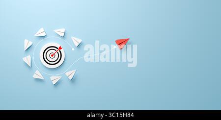 L'enseigne Target est entourée d'avions en papier blanc et un avion en papier rouge s'éloigne du groupe, représentant la différenciation stratégique, la réalisation Banque D'Images