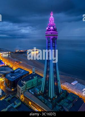 Image aérienne de haute qualité de Blackpool Tower illuminée le long de la Promenade et du front de mer, Lancashire, Royaume-Uni. 20 juillet 2025. Banque D'Images