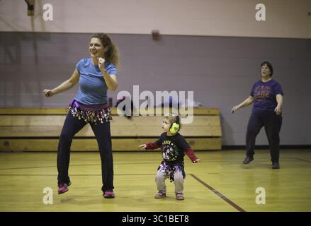 9 novembre 2016 - Minneapolis, MN, U.S.A - Laura Wilhelm a amené sa fille, Annola, 2 ans, à la classe de Zumba mercredi soir. Annola suit les cours avec sa mère depuis avant sa naissance. ....Il y a dix ans, dans l'un de ces moments de marche-la-parole, Allina Health a lancé un grand programme de bien-être pour servir les gens vivant dans le quartier autour de son siège social sud de Minneapolis sur Lake Street. La soi-disant initiative Back Yard a été un flop : elle était descendante, et les voisins n'ont jamais acheté. Depuis lors, ils ont essayé de le reconstruire à partir de zéro, et maintenant un peu funky Banque D'Images