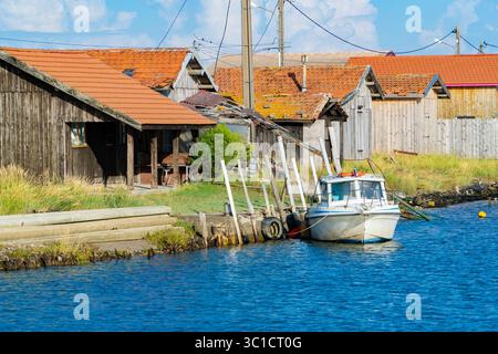 Quai de pêche avec cabanes en bois et bateaux dans la baie atlantique de France Banque D'Images
