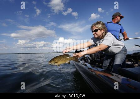 21 juillet 2015 - Isle, MN, États-Unis - Suzy Anderson a jeté un petit bar à bouche dans le lac des mille Lacs mardi. Le département des ressources naturelles du Minnesota a annoncé aujourd'hui que le relevé des nappes de la semaine dernière sur les récoltes estimées, les rejets et les morts de dorés jaunes sur le lac mille Lacs au cours des deux premières semaines de juillet a montré des augmentations drastiques qui pourraient amener l'État à atteindre sa limite d'ici juillet 29. - Le 21 juillet 2015, Isle, MN, Une ''tempête parfaite'' d'événements pourrait amener l'État à fermer la pêche au doré jaune sur le lac mille Lacs le mois prochain -- un mouvement sans précédent sur les lacs de doré jaune les plus populaires du Minnesota, Banque D'Images
