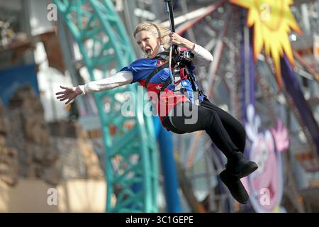 13 novembre 2014 - Minneapolis, MN, États-Unis - habillée en super-héros, Sue Vallafskey de l'école primaire de Hilltop s'est balancée au-dessus de ses élèves sur la tyrolienne Mall of America, jeudi 13 novembre 2014 à Bloomington, MN. Vallafskey s'est joint à d'autres directeurs d'école et enseignants pour sensibiliser à la journée ''Give to the Max'', l'extravagance annuelle qui a permis de recueillir 17 millions de dollars en 24 heures l'an dernier. (/STAR TRIBUNE) (crédit image : Elizabeth Flores/Minneapolis Star Tribune/TNS via ZUMA Wire) Banque D'Images