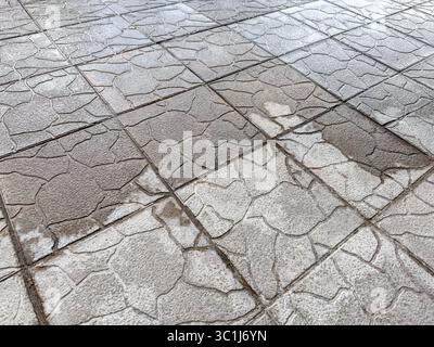 carreaux de chaussée mouillés et secs après la pluie. mauvais temps en ville. Banque D'Images