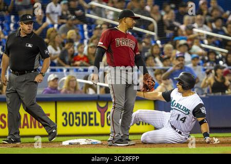 28 juillet 2019, Miami, FL, États-Unis : Martin Prado (14), troisième joueur de base des Miami Marlins, à droite, glisse vers la troisième base en deuxième manche car le ballon n'arrive pas à temps au troisième joueur de base des Arizona Diamondbacks Eduardo Escobar (5) le dimanche 28 juillet 2019 au Marlins Park à Miami, Floride (crédit image : © TNS via ZUMA Wire) Banque D'Images