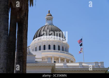 Sacramento, Californie, États-Unis - 21 juin 2025 : bâtiment historique du Capitole de Californie, vue latérale, avec drapeaux californien, américain et lgbtq Banque D'Images