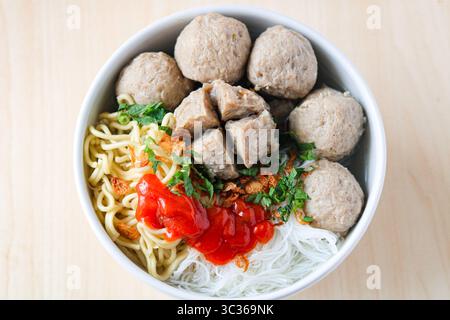 Vue de dessus de Bakso (également connu sous le nom de Baso), une soupe populaire aux boulettes de viande. Le bouillon est rempli de boulettes de viande de bœuf, de nouilles jaunes, de vermicelles et de piment. Banque D'Images
